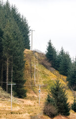 Electricity Pylons Tower Above And Stretch Across The Landscape Of The United Kingdom