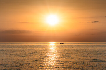 Small Boat on the Sea at Sunset