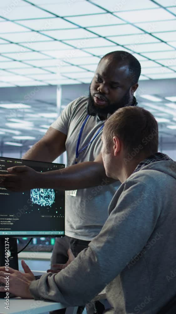Poster technician doing brainstorming with colleagues to fix error in code affecting server room ai workloa