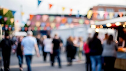 An abstract blur of a crowd at an outdoor festival, with food stalls and colorful banners.
