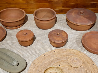 Traditional clay pottery display showcasing various handcrafted vessels and artifacts in a rustic setting