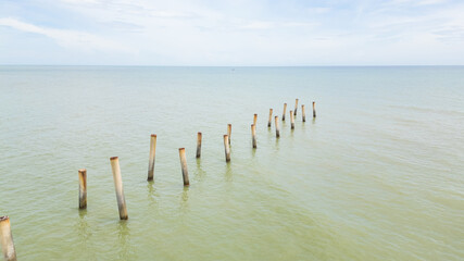 Fototapeta premium Beach Serenity.Old Posts and Calm Waters