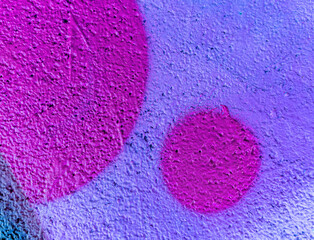 Beautiful colorful street art graffiti background. The wall is decorated with abstract drawings house paint. Modern style urban culture of street youth. Abstract picture on wall