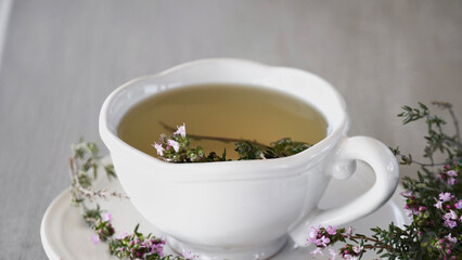 Close up tea cup thyme medicinal properties.