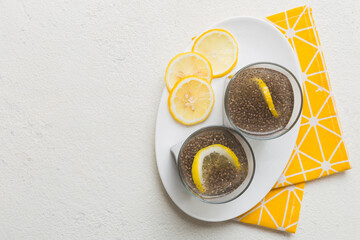 Healthy breakfast or morning with chia seeds and lemon on table background, vegetarian food, diet and health concept. Chia pudding with lemon