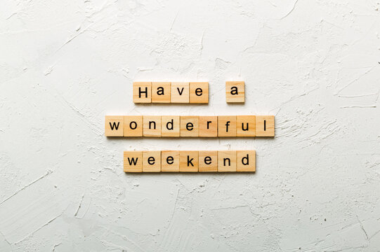 Have a wonderful weekend word written on wood block. Have a wonderful weekend text on cement table for your desing, Top view concept