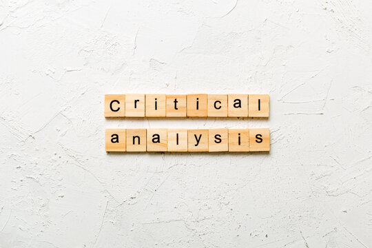 critical analysis content word written on wood block. critical analysis content text on table, concept