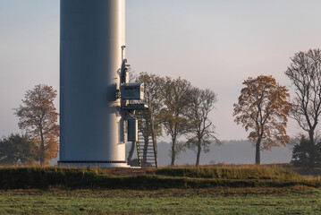 Obraz premium WIND FARM - Entrance to the turbine against the backdrop of an autumn landscape 
