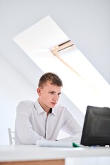 Naklejka premium Portrait of high school student in white uniform with laptop, distance online learning