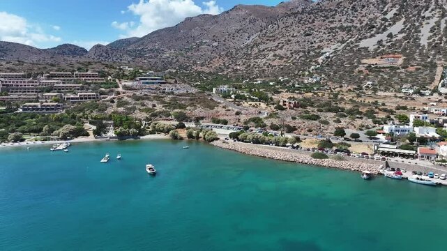 Plaka Marina and Spinalonga Island Crete, Greece. High quality 4k footageThis video captures the tranquil Plaka Marina with its fishing boats and serene coastal views, set against the backdrop of