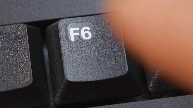 F6 or F Six Key on Desktop Keyboard Pressed by Finger Hand Multiple Times - Close Up Macro Shot