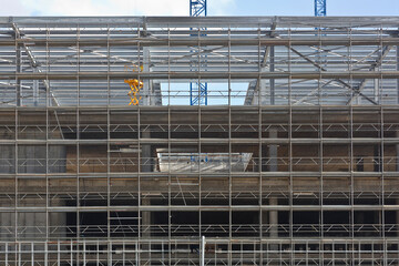 Construction of a new reinforced concrete building with metal safety scaffolding