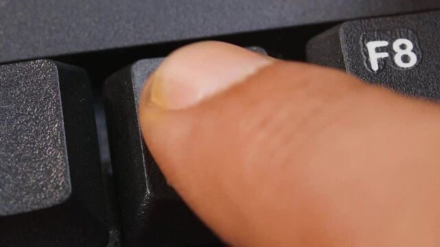 F7 or F Seven Key on Desktop Keyboard Pressed by Finger Hand Multiple Times - Close Up Macro Shot