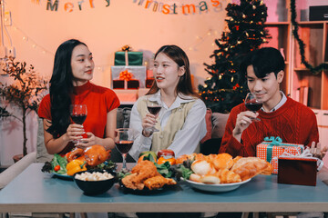 Friends opening Christmas gifts in living room