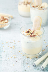 Milk mousse dessert with nuts in glasses