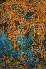 Rusty metal surface with shabby background paint. Blue cracked paint texture on an iron sheet. Fragment of an old metal door, Metal corrosion.