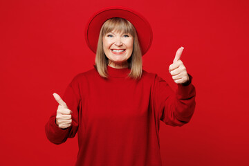 Elderly smiling happy cheerful blonde woman 50s years old wear sweater hat casual clothes showing...