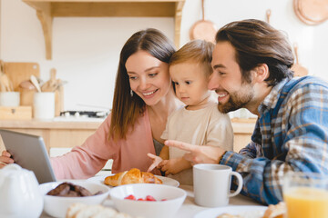 Child developing cartoons video. Caucasian happy parents watching animated movies, having videocall...