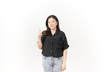 beautiful Asian woman poses with her hands raised to show the number one against a white background