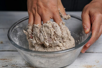 kneading wholegrain bread dough with hand