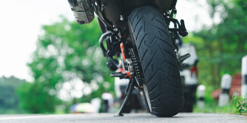 Motorcycle cruising down the road under the golden sunset, basking in the warm glow. A perfect...
