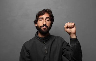 feeling serious, strong and rebellious, raising fist up, protesting or fighting for revolution