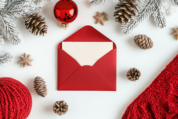 A blank white card with a red festive envelope. Christmas card or invitation