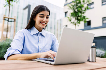 Young adult student woman using laptop computer while learning online MBA or business master....