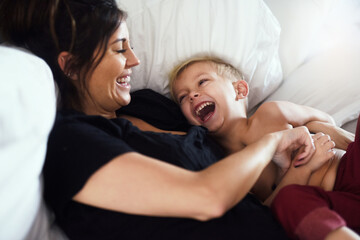 Laughing, playing and mom with child in bedroom for bonding, love and fun relationship in morning....