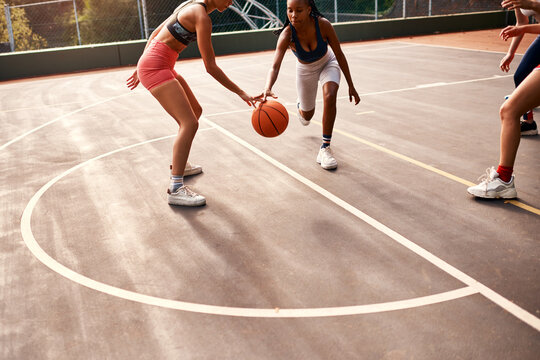 Women, sports and ball on basketball court as team or athlete for challenge, cardio and training. Female people, warm up and outdoor with competition, match or player as physical activity or exercise