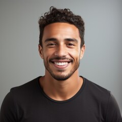 Obraz premium Brazilian man in relaxed attire with friendly smile against a colorful studio background