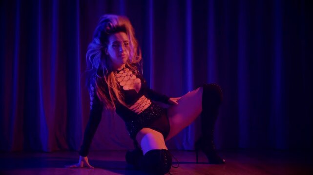 Sexy woman dancing a seductive dance. A dancer in high heels, bathed in vibrant hues, embodies the stage's electrifying energy. Fluid movements, high heels, a performance burlesque