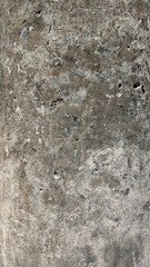 Abstract texture of concrete surface with varied shades and imperfections.