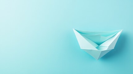 Minimalist Blue Background with a Folded Paper Boat