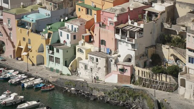 View of boats and restaurants in Marina di Corricella from elevated position, Procida, Phlegraean Islands, Gulf of Naples, Campania, Southern Italy, Italy