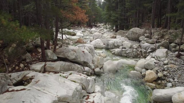 Aerial drone flying above stream river in Restonica valley, serene nature