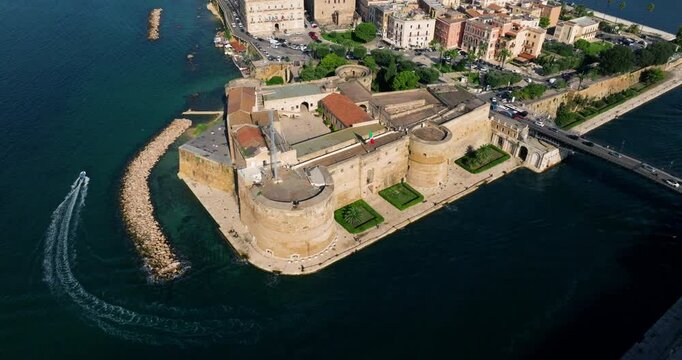 The Castello Aragonese Fortification In The Old Town Of Taranto, Puglia Italy. Aerial Pullback Shot