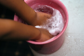 Fototapeta premium close up of child's hand with soap foam