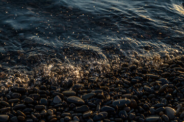 Water sea beach. Wave ocean blue. Stone texture reflection sun. Surface coast pebbles. Abstract light rock background.