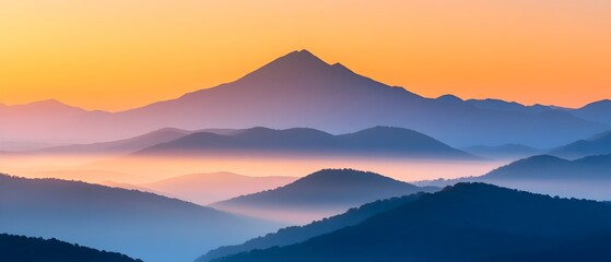 Obraz premium Breathtaking mountain landscape at sunrise with mist rolling through the valleys and golden sunlight casting soft highlights on the rugged peaks A tranquil and natural scene