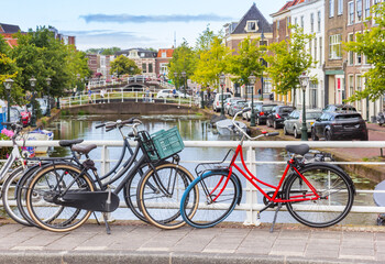 Fototapeta premium Bicycles parked on the bridge over the Nieuwe Mare canal in Leiden, Netherlands