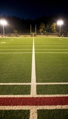 Fototapeta premium Empty Football Field Illuminated at Night With Bright Stadium Lights, Game Day Atmosphere