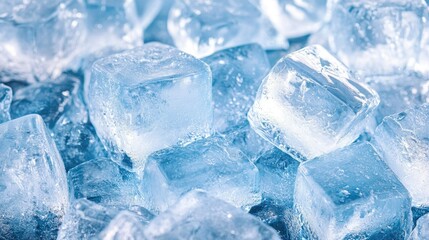 Assortment of ice cubes glistening on a dark background, creating contrast. Copy space