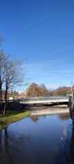 bridge on the river beneath a blue sky