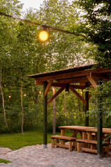 Simple wooden gazebo in forest