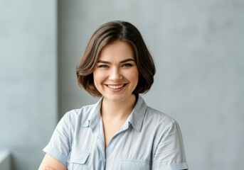 Fototapeta premium Portrait of a smiling woman with a light blue shirt