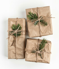 Christmas presents wrapped in craft paper with small pine branches
