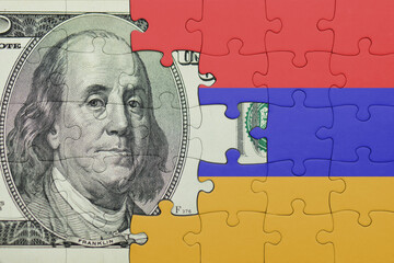 puzzle with the national flag of armenia and the usa dollar money .finance concept