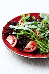Healthy Salad with Feta Cheese, Black Olives, Cucumber and Cherry Tomatoes. Wooden background. Close up.