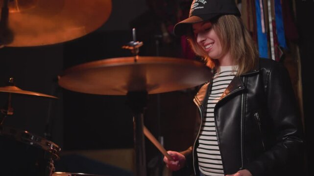
a girl learns to play the drums